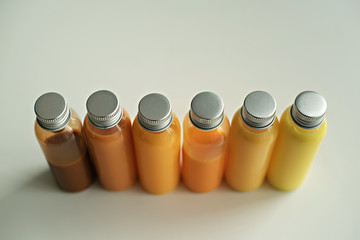 bottles with colored liquid on a light background . Multi-colored container