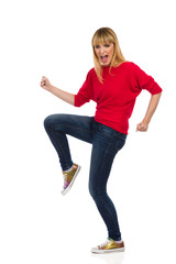The Woman Stands On One Leg With A Raised Fist And Shoutes