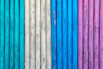Colorful wooden boards painted in cyan, white, blue and purple colors. Multicolored texture background.
