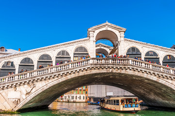 Detail of the Rialto and a Vaporetto passing underneath in Venice in Veneto, Italy