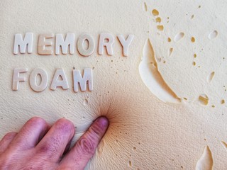 Finger presses on memory foam cushion