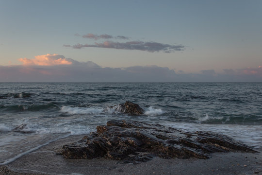 ocean and rocks during sunrise
