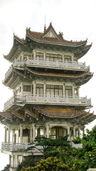 Naklejka premium Chinese Buddhist Temple in China, Asia, traditional oriental architecture, monastery on the peak of the hill at the National Nanling Park, sunrise in the early morning, travel and tourism concept