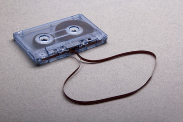 Cassette with removed tape on grey background