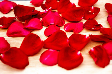 Fototapeta na wymiar Picture of rose petals on a wooden background