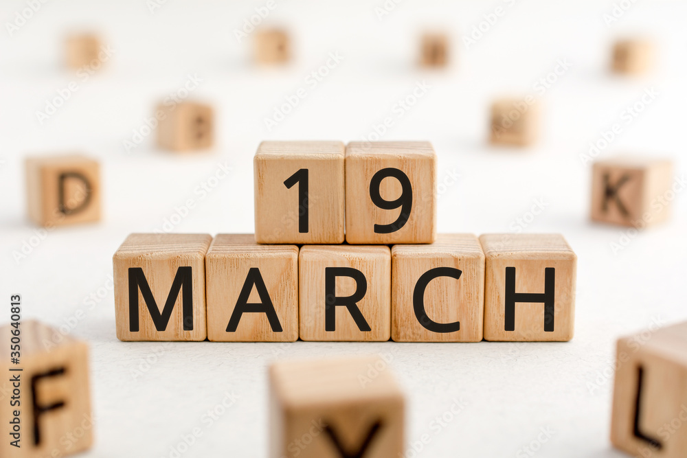 Poster march 19 - from wooden blocks with letters, important date concept, white background random letters 