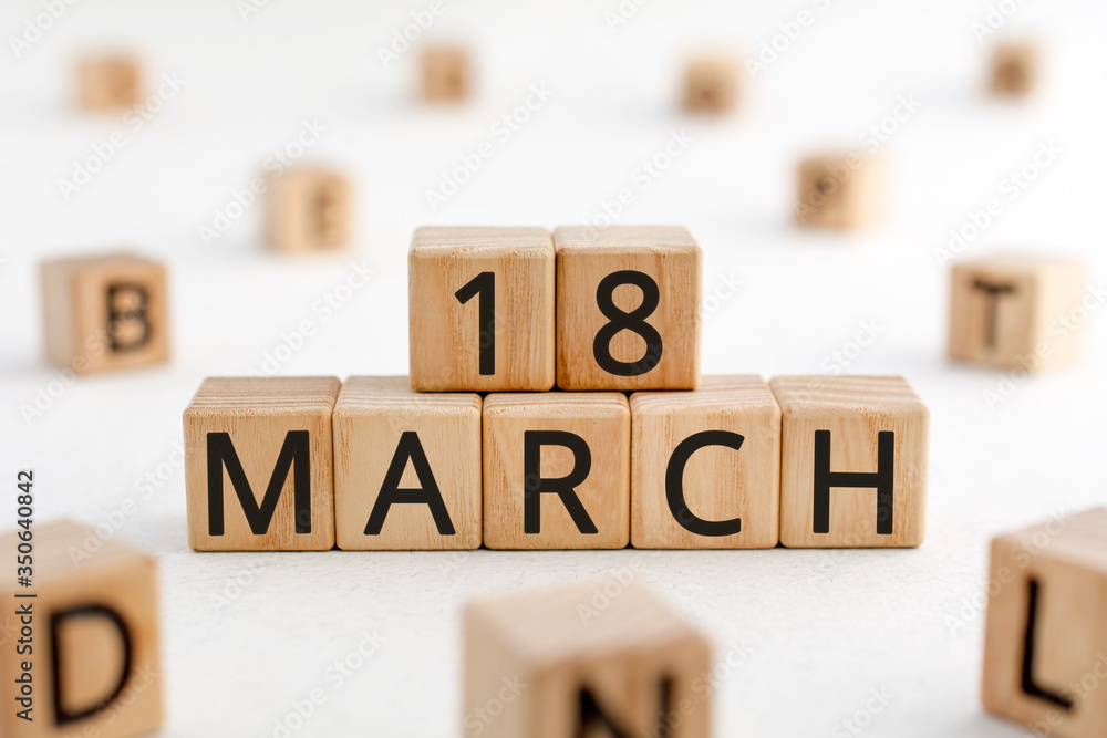 Poster march 18 - from wooden blocks with letters, important date concept, white background random letters 