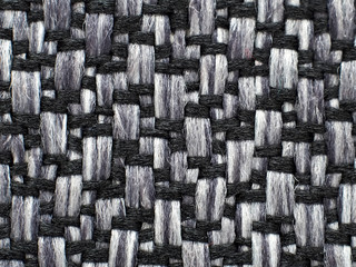 Closeup of gray, black woven fabric, abstract background.