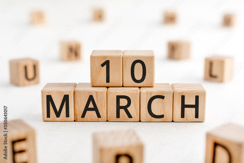 Poster march 10 - from wooden blocks with letters, important date concept, white background random letters 