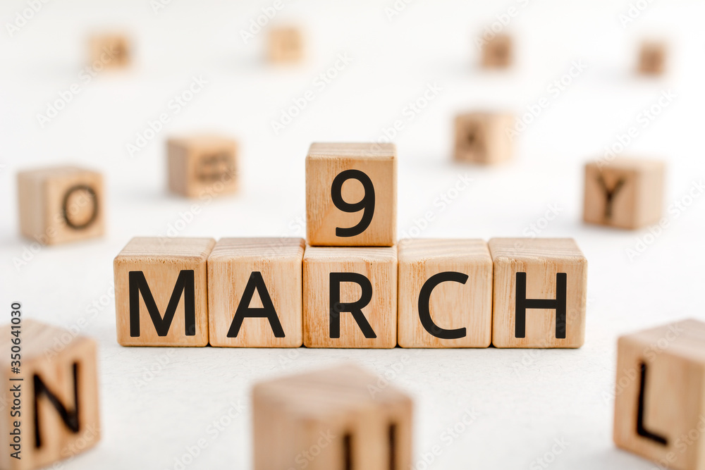 Poster march 9 - from wooden blocks with letters, important date concept, white background random letters a