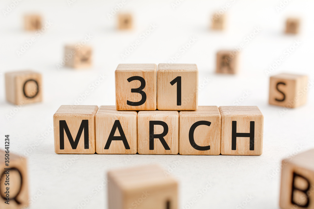 Poster march 31 - from wooden blocks with letters, important date concept, white background random letters 