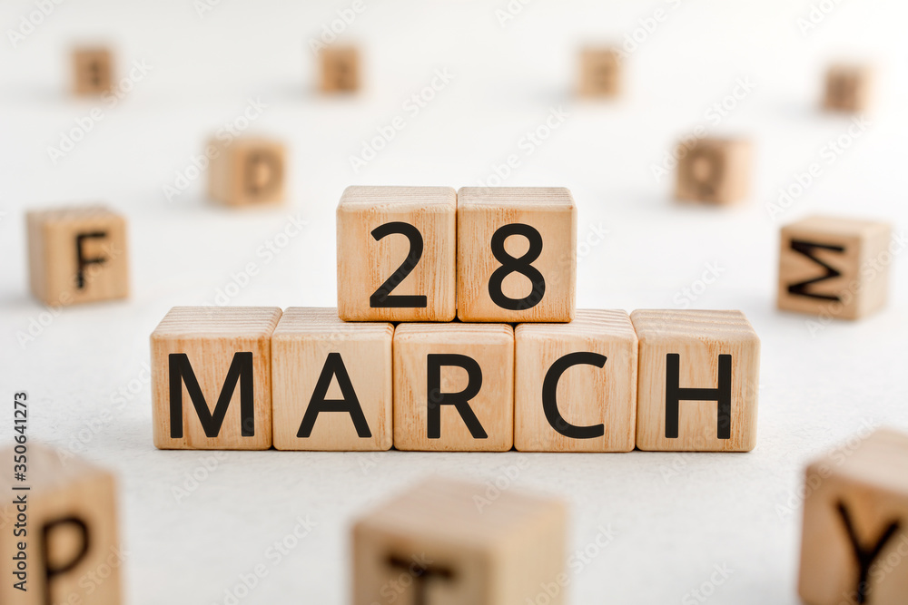 Poster march 28 - from wooden blocks with letters, important date concept, white background random letters 