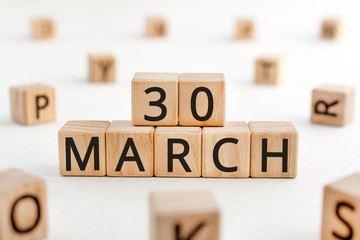March 30 - from wooden blocks with letters, important date concept, white background random letters...