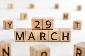 March 29 - from wooden blocks with letters, important date concept, white background random letters around