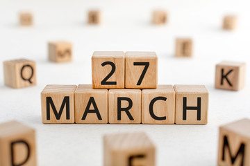 March 27 - from wooden blocks with letters, important date concept, white background random letters...