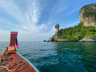 Sailing with a longtail private boat to Ko Poda Chicken island landscape with big rocks and turquoise water surface, Krabi, Thailand