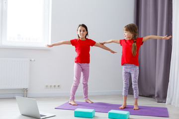 Fototapeta na wymiar Full-length image little girls having fun at home sportive active kid girl. Funny leisure activities, sporty healthy lifestyle concept