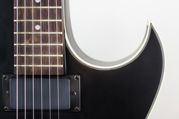 Black electric rock guitar with humbucker pickup close up macro shot