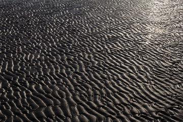 Patterns of sand on the beach during ebb tide