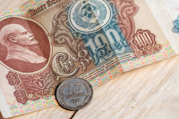 old soviet coins and paper bills on a wooden table