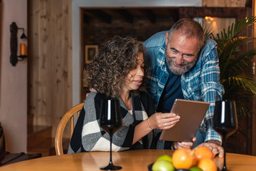 older couple drinking wine and making a video call