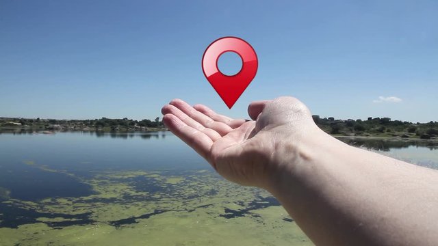 hand with a geolocator icon in the field