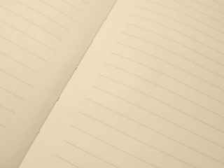 Open beige exercise book with horisontal stripes