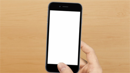 a hand touching a smarphone with white screen in wooden texture background