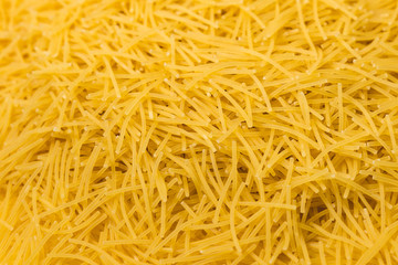 Dry vermicelli pasta ready for cooking. close up with copy space. Food photo.