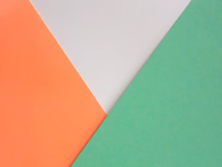 Abstract minimalistic tricolor background. White, orange and green paper in triangular and polygon...