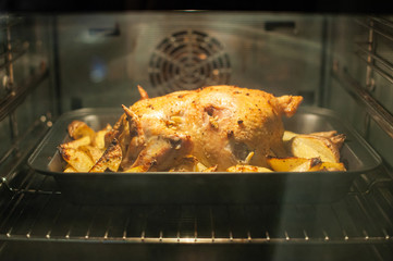 Fried chicken with baked potatoes and in the oven