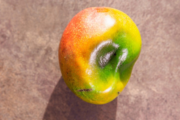 Ugly food mango close-up on dark background, place for copispace
