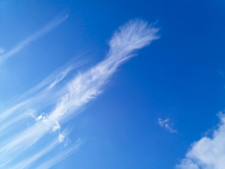 Fototapeta na wymiar A deep blue sky with clouds like a sword hilt