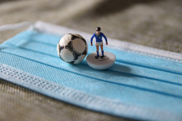 Italian plastic football player with ball and surgical mask for Coronavirus Prevention - Covid19 pandemic