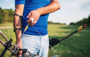 Archer. Sportsman practicing archery, close up photo. Sport, recreation concept