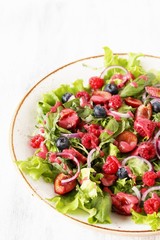Salad with berries-raspberry, blueberry, sweet cherry. Dressed with raspberry vinaigrette. Soft focus. copy space