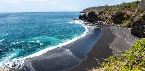 Black sand volcanic beach in Bali, Indonesia