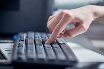 Female hands or woman office worker typing on the keyboard