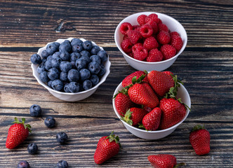Berries, summer fruits on a wooden table. Healthy lifestyle concept. Selective focus