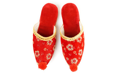 Red embroidered Turkish slippers, decorative footwear isolated on white