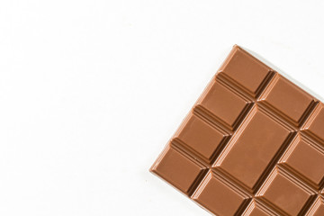 Milk chocolate bar isolated on white background.