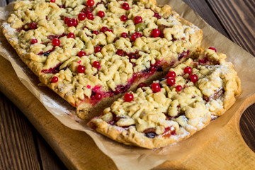 sliced ​​homemade grated pie with berries
