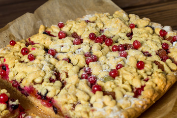 sliced ​​homemade grated pie with berries