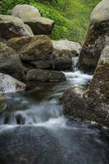 Fototapeta na wymiar boulders with flowing water