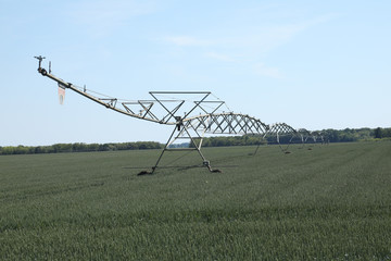 Central pivot irrigation system watering an alfalfa field
