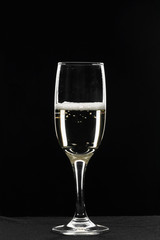 Champagne in a glass of wine on a black background