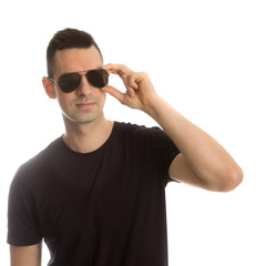 Naklejka premium Headshot of a young man wearing aviator sunglasses, isolated on white
