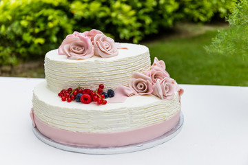 Obraz na płótnie Canvas White wedding cake with red fruits.