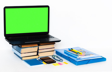 Work from home, mobile, green screen laptop computer, books and notebook. Education background, workplace at home during the pandemic. The quarantine concept of stay home stop coronavirus COVID-19.