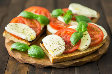 Fototapeta na wymiar Healthy homemade sandwich with tomato, mozzarella and basil